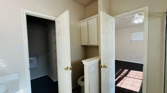 a bedroom with a bed and painting on the wall