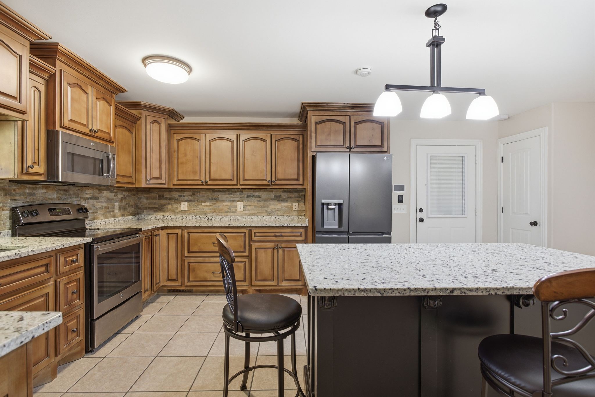 408 Weakley Creek Road Lawrenceburg, TN 38464 - Photo 11 of 41 a kitchen with granite countertop a sink cabinets and stainless steel appliances