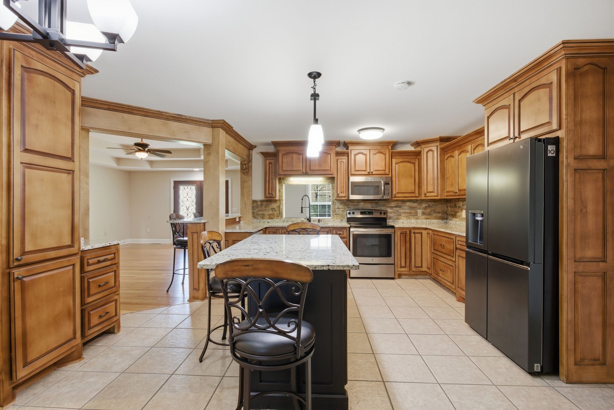 408 Weakley Creek Road Lawrenceburg, TN 38464 - Photo 13 of 41 a kitchen with refrigerator a sink and cabinets