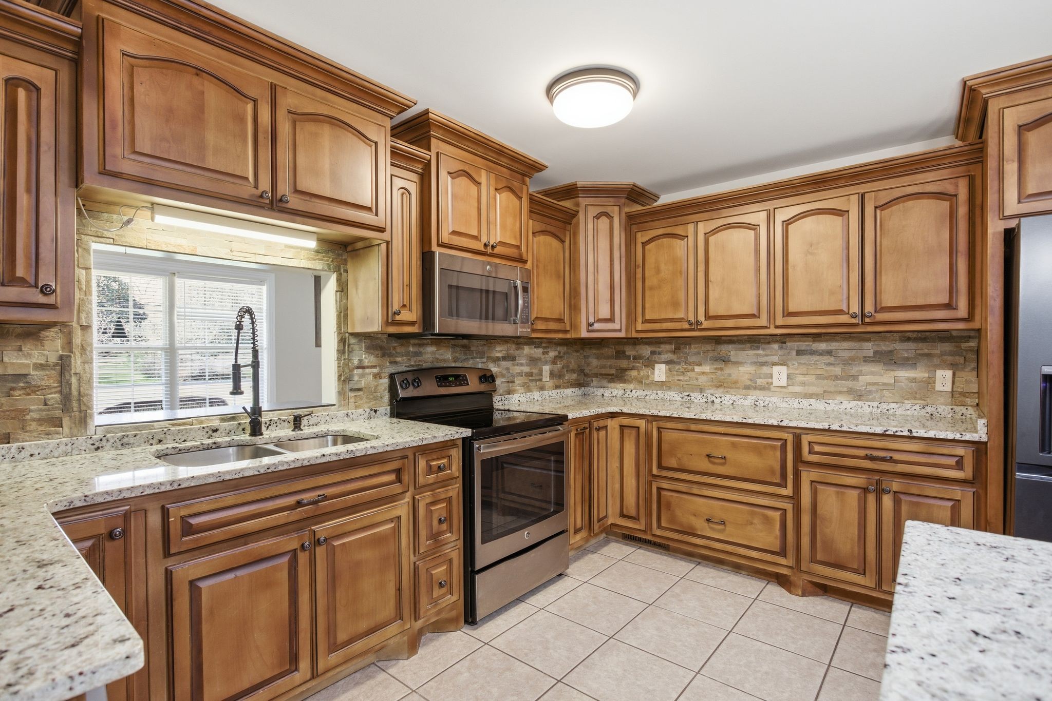 408 Weakley Creek Road Lawrenceburg, TN 38464 - Photo 14 of 41 a kitchen with stainless steel appliances granite countertop a sink and cabinets