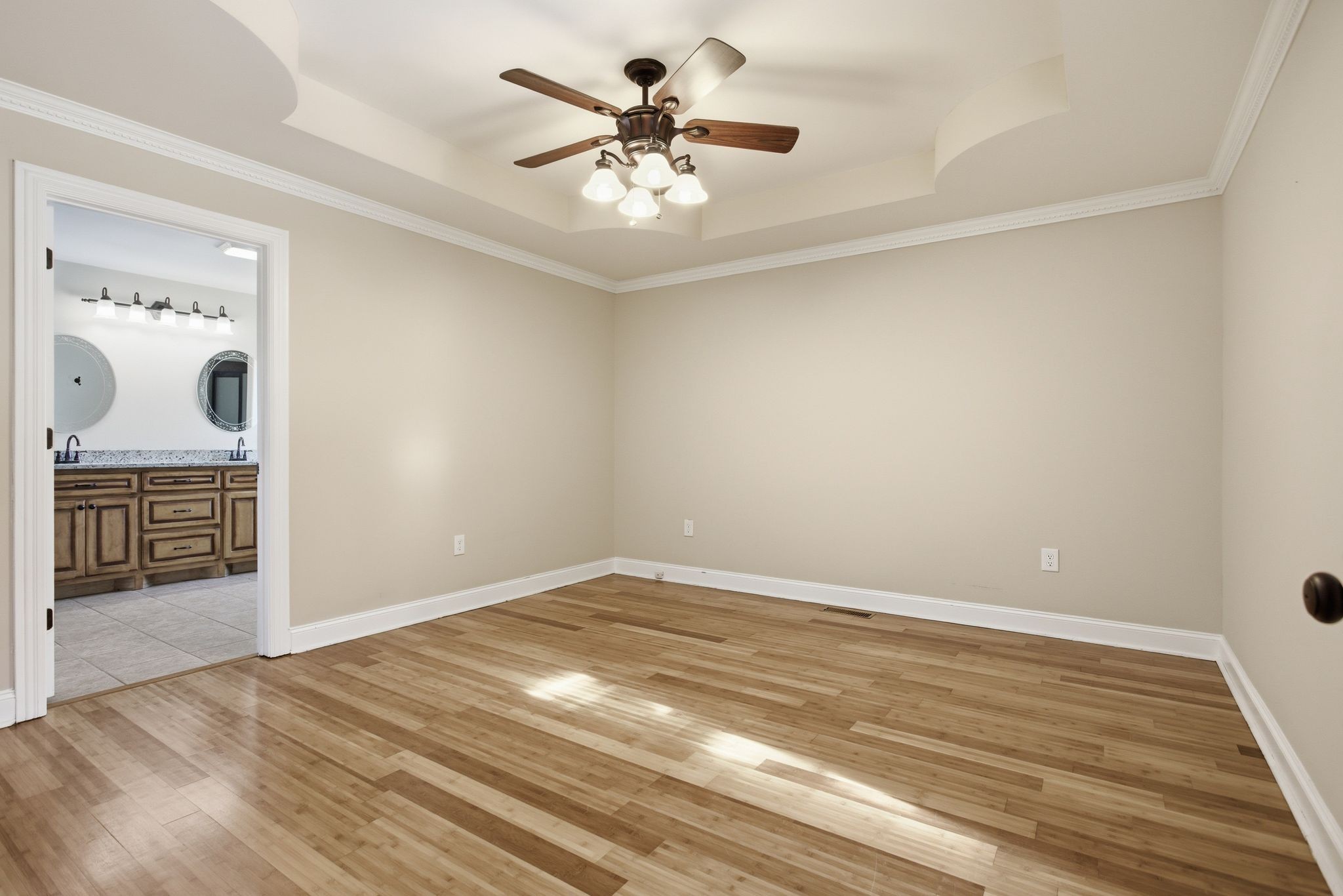 408 Weakley Creek Road Lawrenceburg, TN 38464 - Photo 16 of 41 wooden floor in an empty room with a chandelier fan