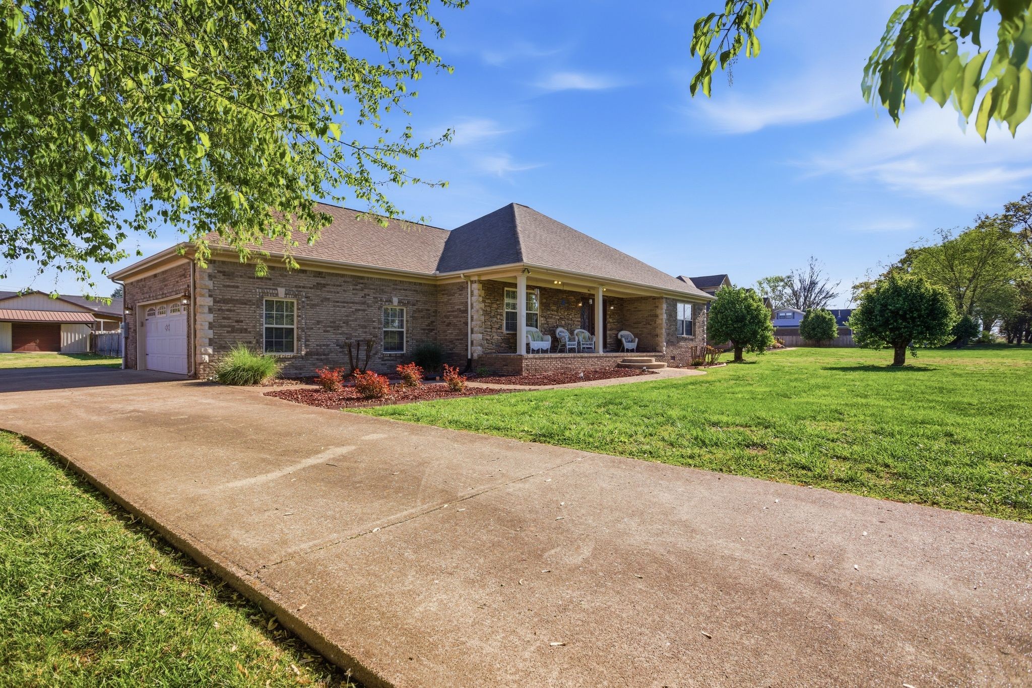 408 Weakley Creek Road Lawrenceburg, TN 38464 - Photo 3 of 41 a front view of a house with a yard and potted plants