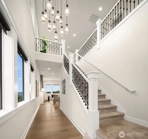 a view of entryway and hall with wooden floor