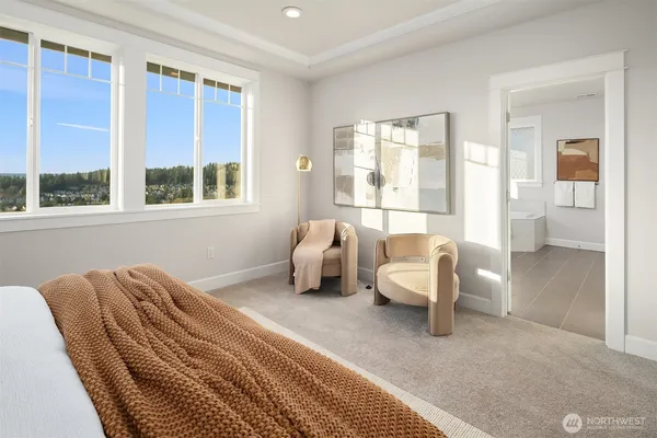 a bedroom with furniture and a large window