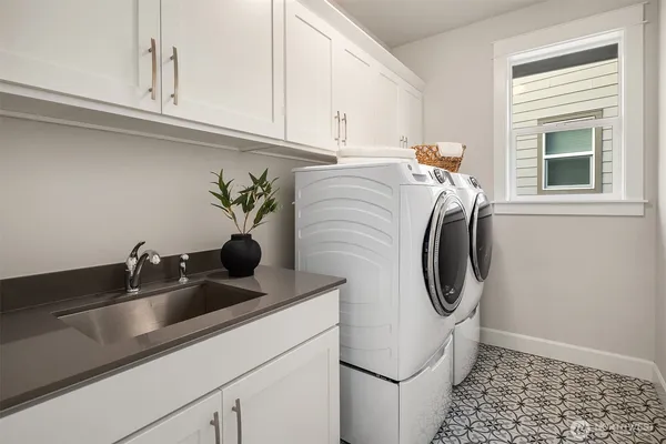 a utility room with a sink a washer and dryer