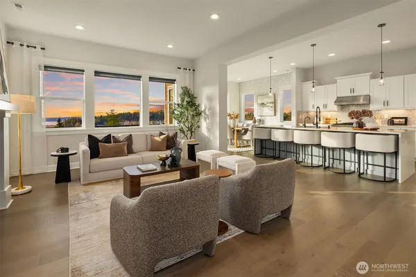 a living room with fireplace furniture and a large window