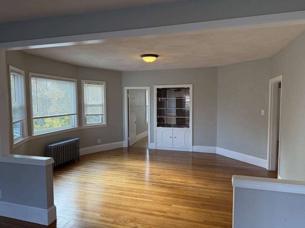 148 George Street, Unit 2 Medford, MA 02155 - Photo 11 of 26 a view of an empty room with glass door and a window