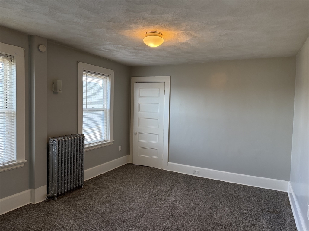 148 George Street, Unit 2 Medford, MA 02155 - Photo 17 of 26 an empty room with windows and vanity
