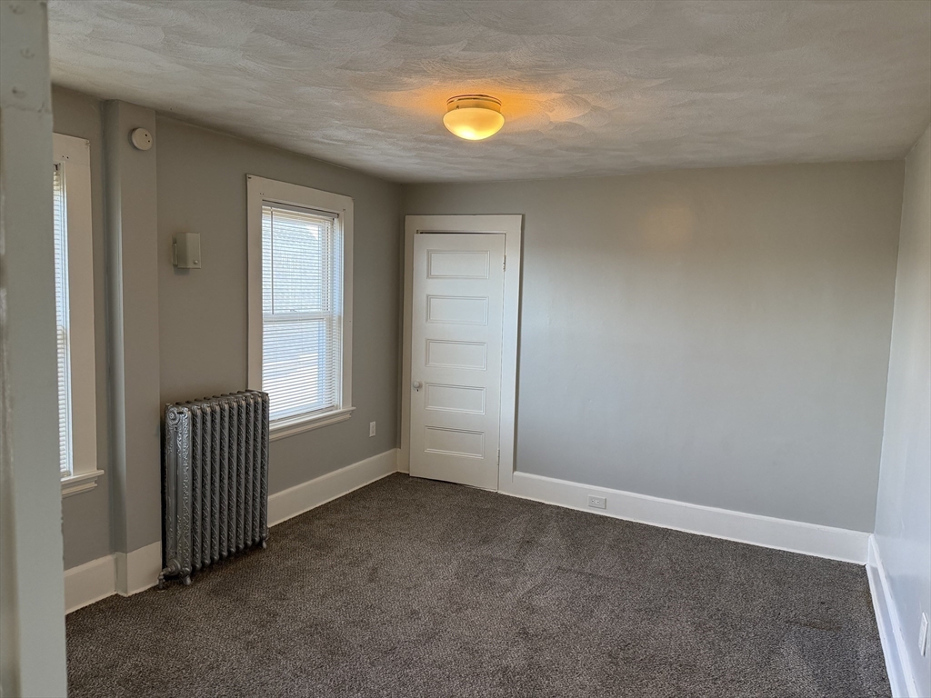 148 George Street, Unit 2 Medford, MA 02155 - Photo 19 of 26 an empty room with windows and closet