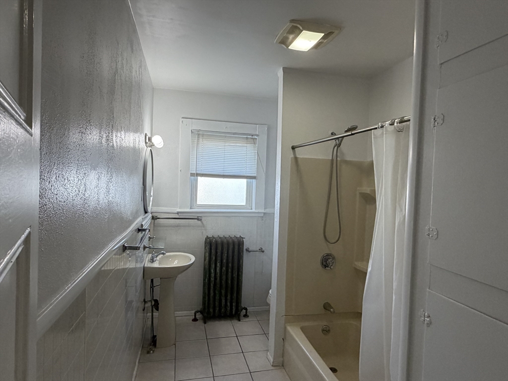 148 George Street, Unit 2 Medford, MA 02155 - Photo 25 of 26 a bathroom with a shower a sink and a mirror