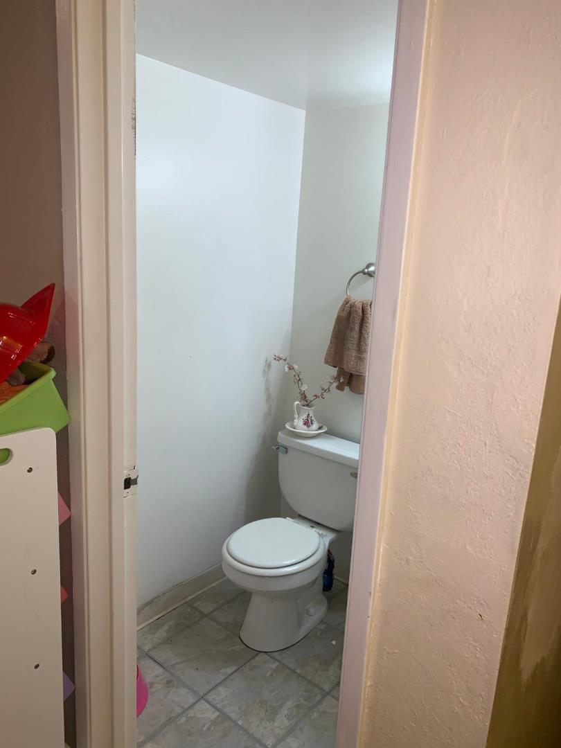 2043 Sierra Road, Unit 1 Concord, CA 94518 - Photo 12 of 34 a white toilet sitting next to a bathroom sink and vanity
