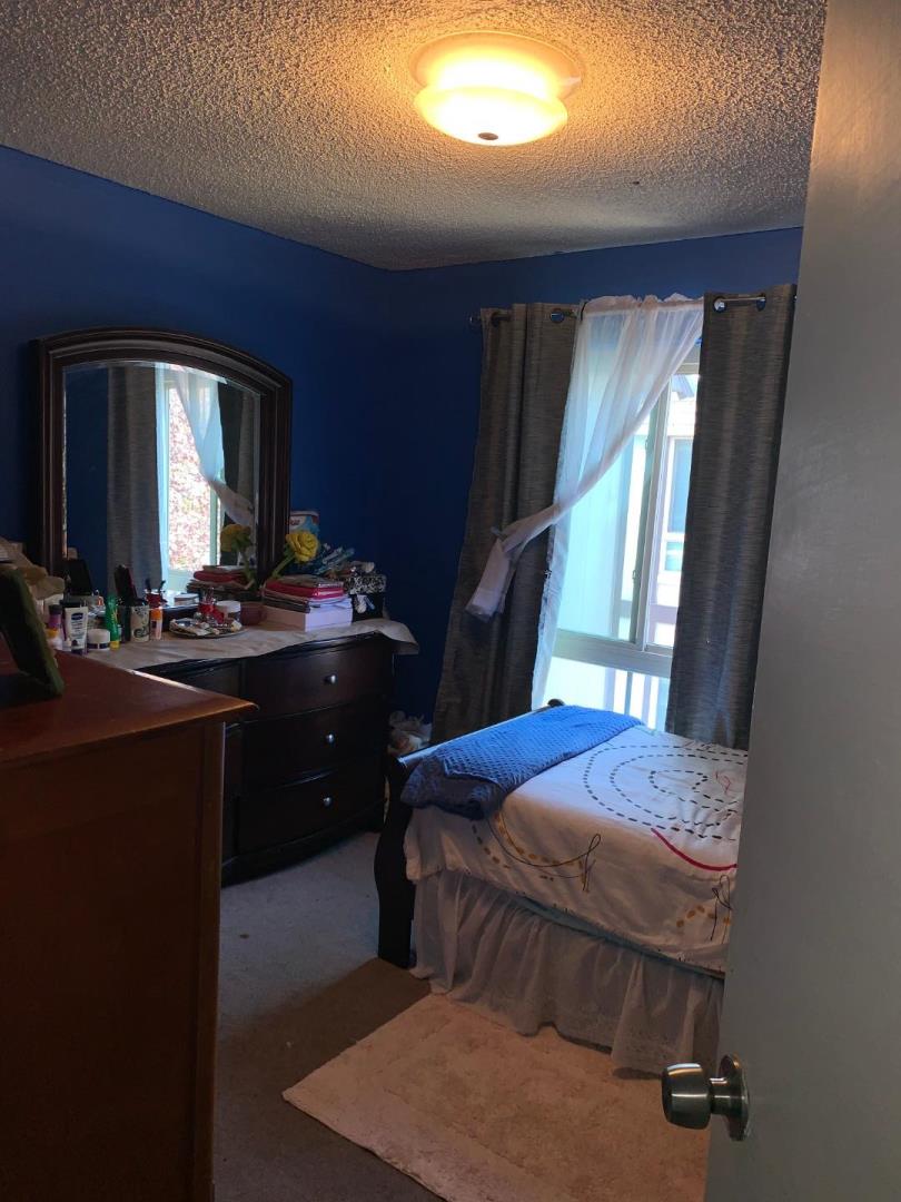 2043 Sierra Road, Unit 1 Concord, CA 94518 - Photo 15 of 34 a bedroom with a bed and large windows