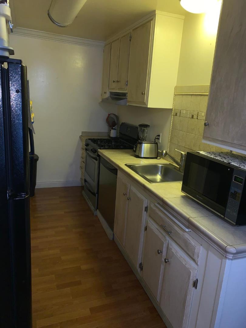 2043 Sierra Road, Unit 1 Concord, CA 94518 - Photo 10 of 34 a kitchen with a sink and a stove top oven