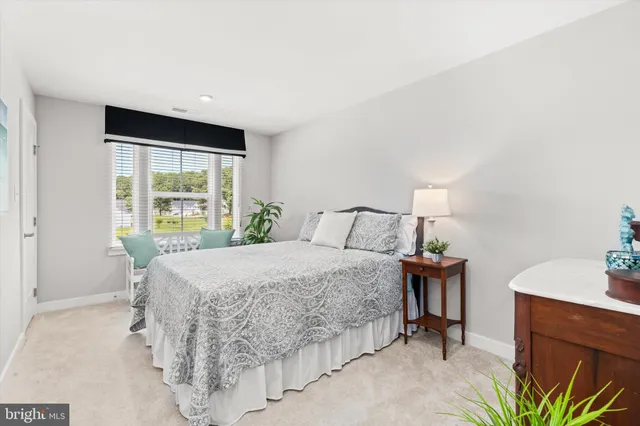 a bedroom with a bed and a table