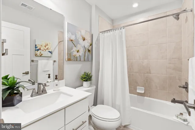 a kitchen with stainless steel appliances a stove a microwave a sink and cabinets