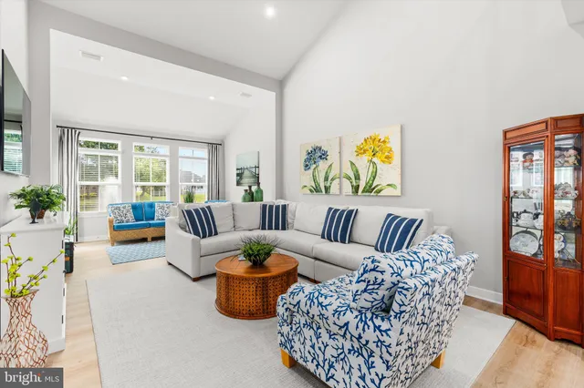 a living room with furniture potted plant and table