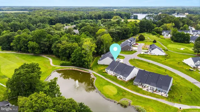 an aerial view of residential houses with outdoor space and swimming pool