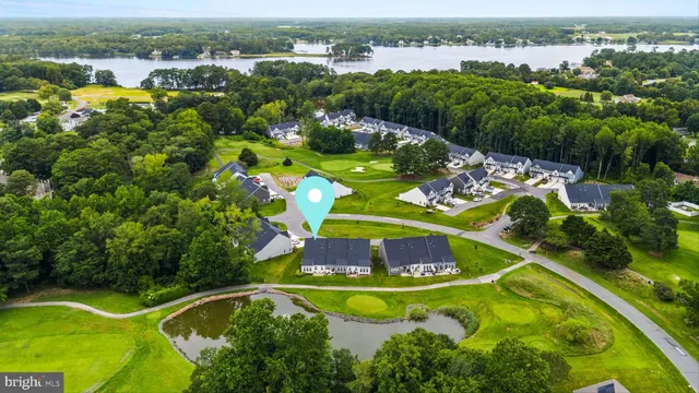 an aerial view of residential houses with outdoor space and swimming pool