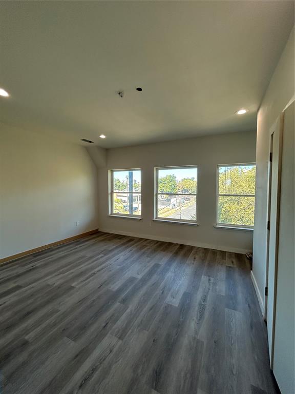 1401 Seegar Street Dallas, TX 75215 - Photo 11 of 17 an empty room with wooden floor and windows