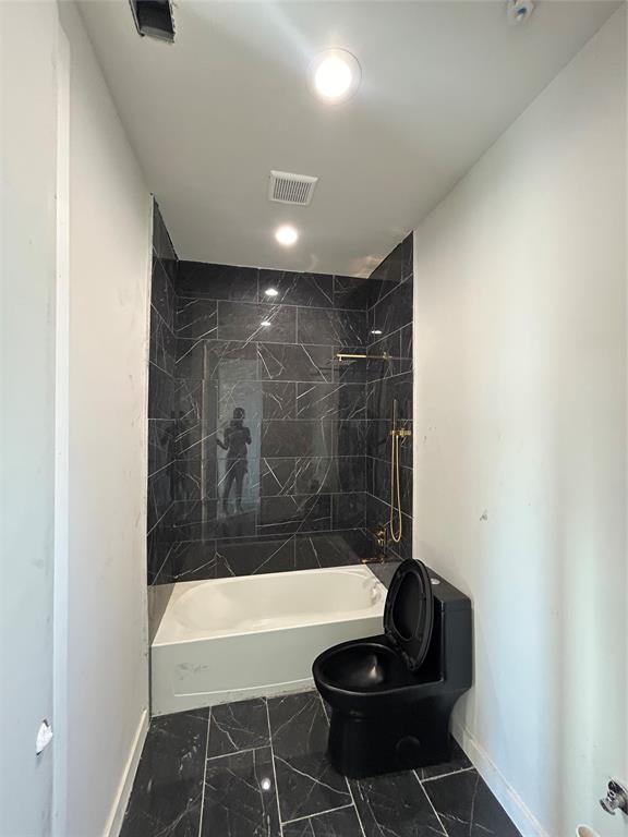 1401 Seegar Street Dallas, TX 75215 - Photo 4 of 17 a bathroom with a bathtub and shower