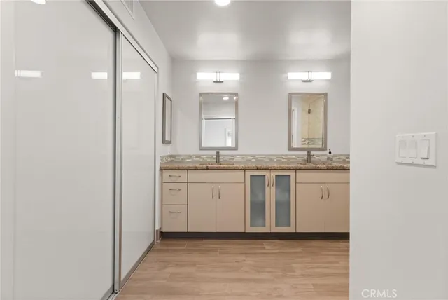 a bathroom with a granite countertop sink and a mirror