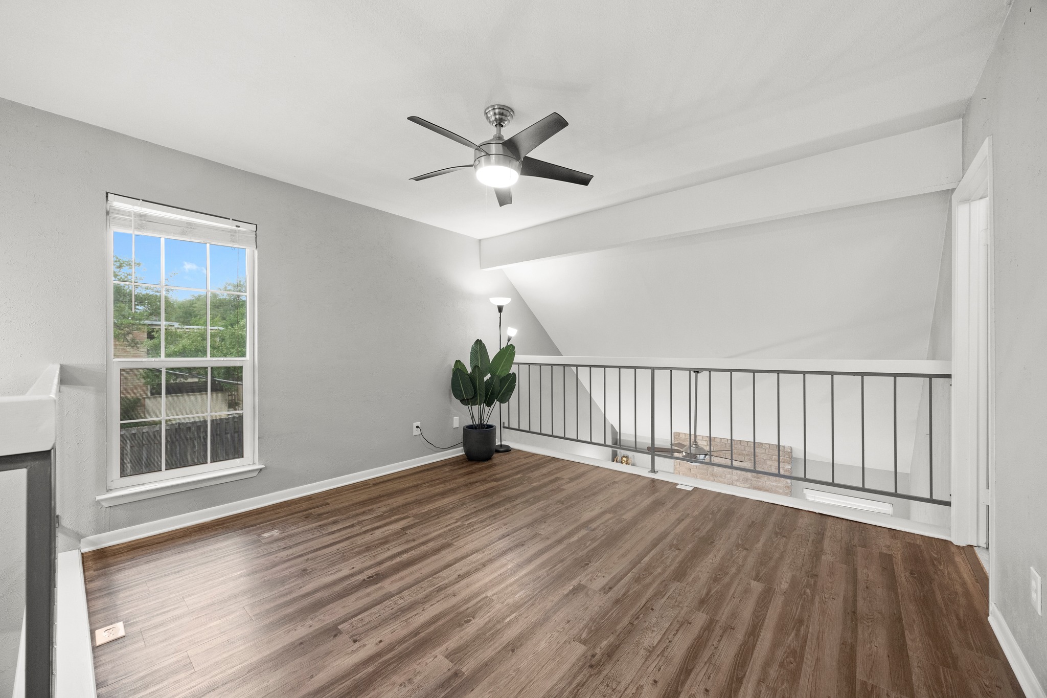 8330 Fathom Circle, Unit 501 Austin, TX 78750 - Photo 14 of 26 a view of an empty room with wooden floor and a window