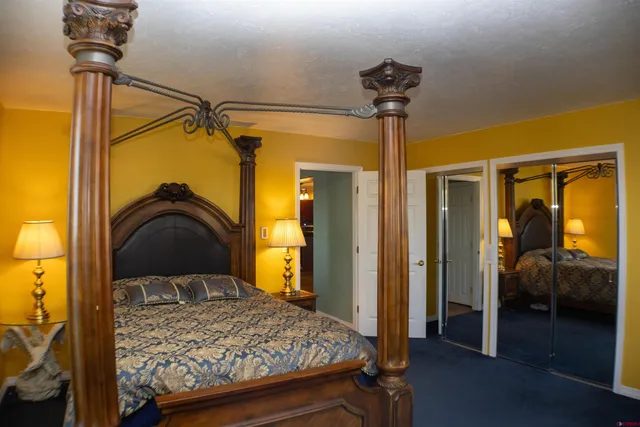 a bedroom with a bed and a view of living room