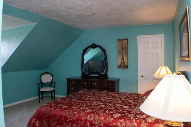 a bedroom with a bed and a potted plant