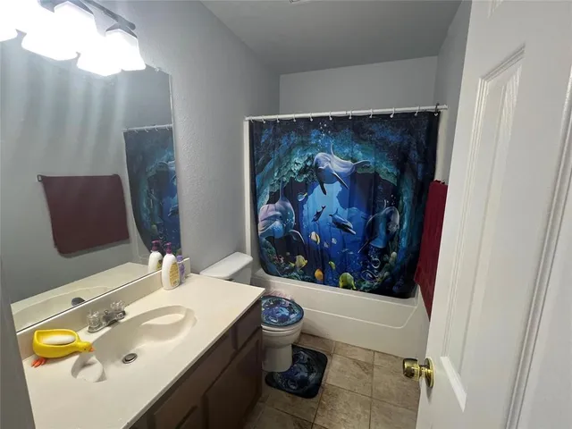 a bathroom with a sink mirror and vanity