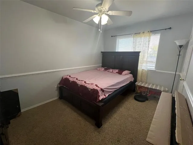 a bed sitting in a bedroom next to a window