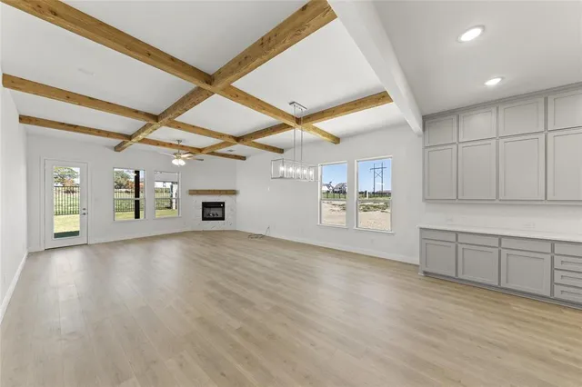 a view of an empty room with window and cabinet