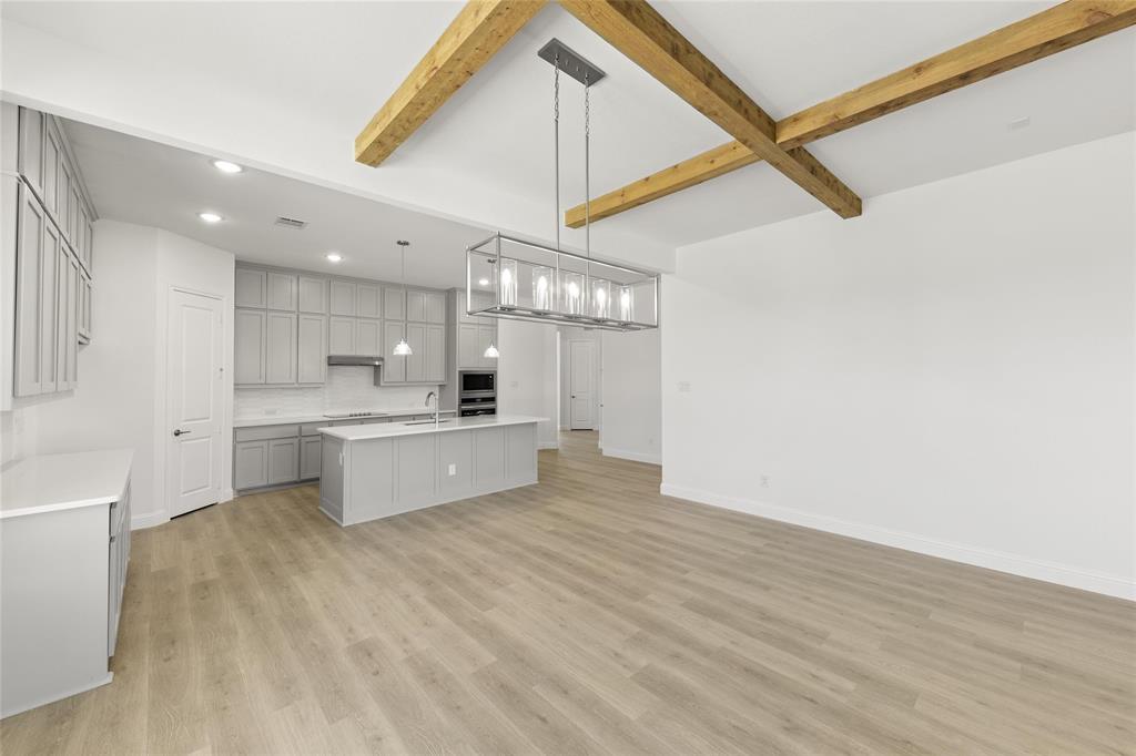4017 Eagles Bluff Road Midlothian, TX 76065 - Photo 15 of 31 a large kitchen with kitchen island a sink stainless steel appliances and cabinets