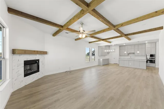 a view of a livingroom with a fireplace and a ceiling fan