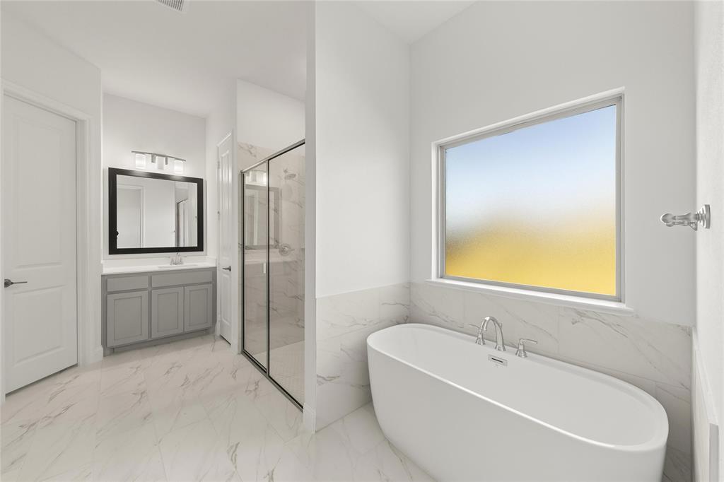 4017 Eagles Bluff Road Midlothian, TX 76065 - Photo 22 of 31 a spacious bathroom with a tub sink and mirror