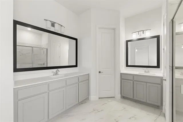a bathroom with a sink vanity and mirror