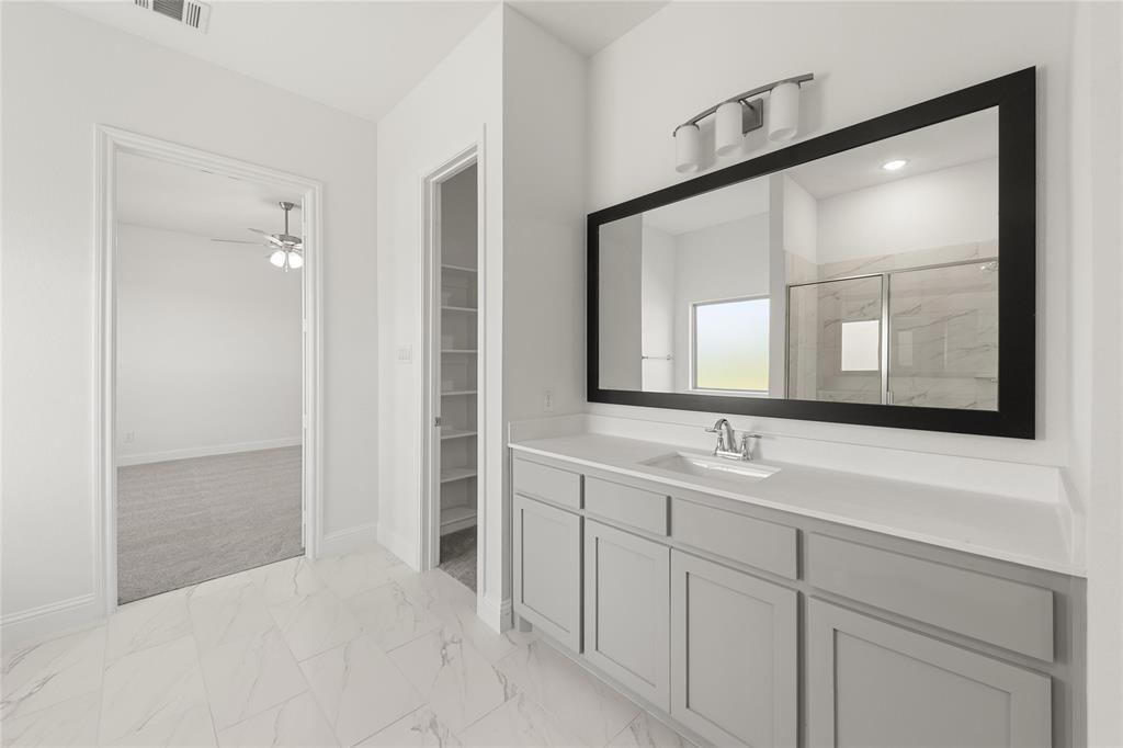 4017 Eagles Bluff Road Midlothian, TX 76065 - Photo 24 of 31 a bathroom with a sink and a mirror