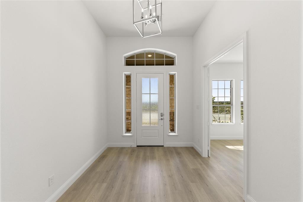 4017 Eagles Bluff Road Midlothian, TX 76065 - Photo 5 of 31 an empty room with wooden floor and windows