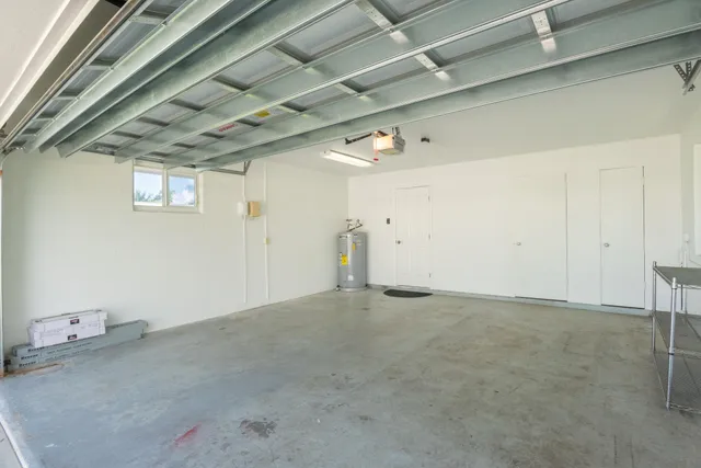 a view of a white house with a yard and plants