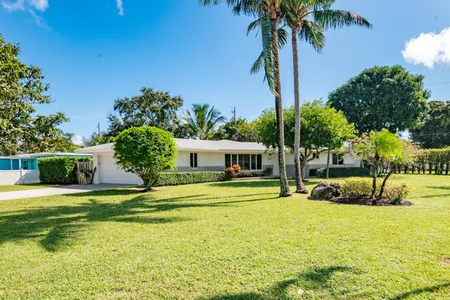 a swimming pool with outdoor seating and yard