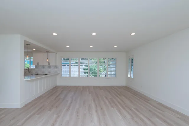 a view of an empty room and a window