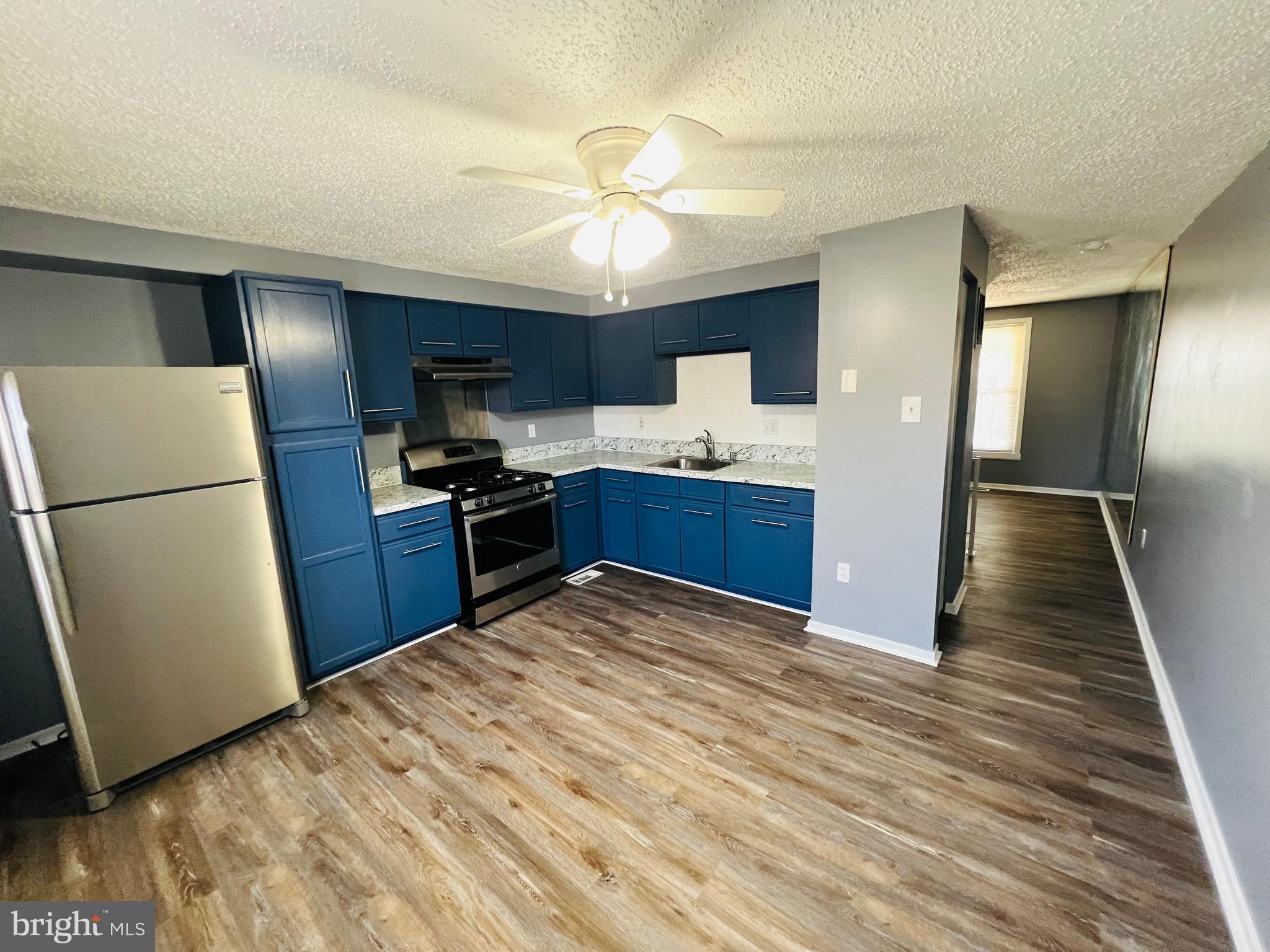 1808 North Spring Street Baltimore, MD 21213 - Photo 12 of 24 a kitchen with granite countertop a refrigerator and a sink
