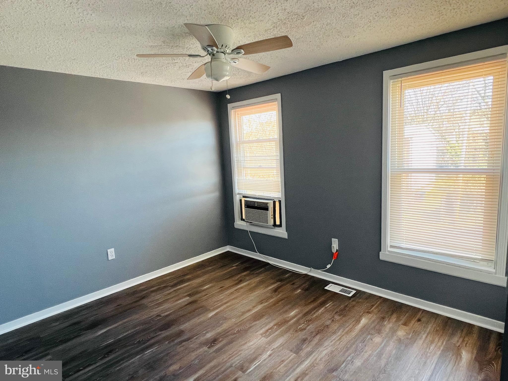 1808 North Spring Street Baltimore, MD 21213 - Photo 14 of 24 a view of an empty room with wooden floor and a window