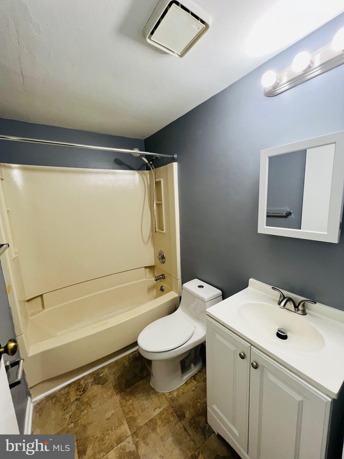 1808 North Spring Street Baltimore, MD 21213 - Photo 17 of 24 a bathroom with a sink toilet vanity and shower