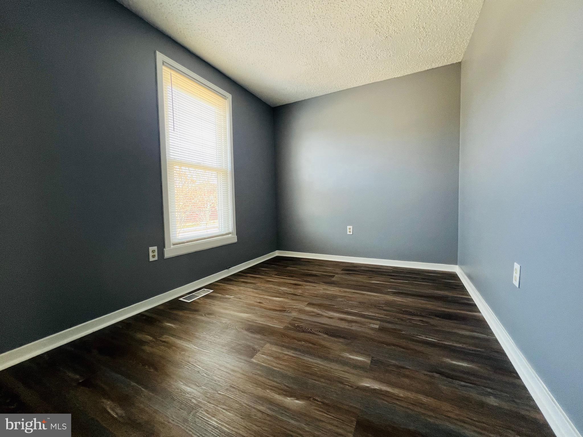 1808 North Spring Street Baltimore, MD 21213 - Photo 18 of 24 an empty room with wooden floor and windows