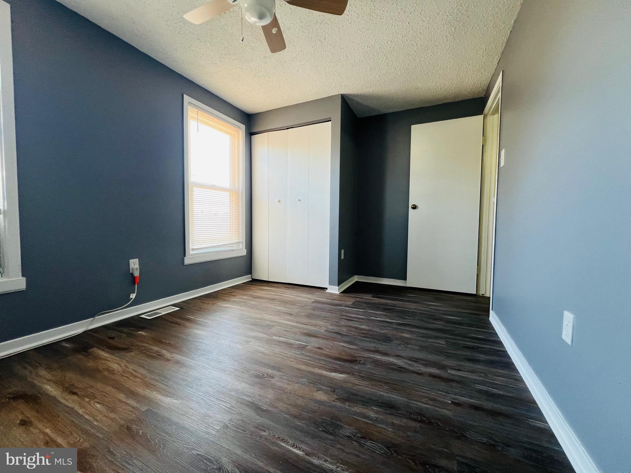 1808 North Spring Street Baltimore, MD 21213 - Photo 19 of 24 wooden floor in an empty room with a window