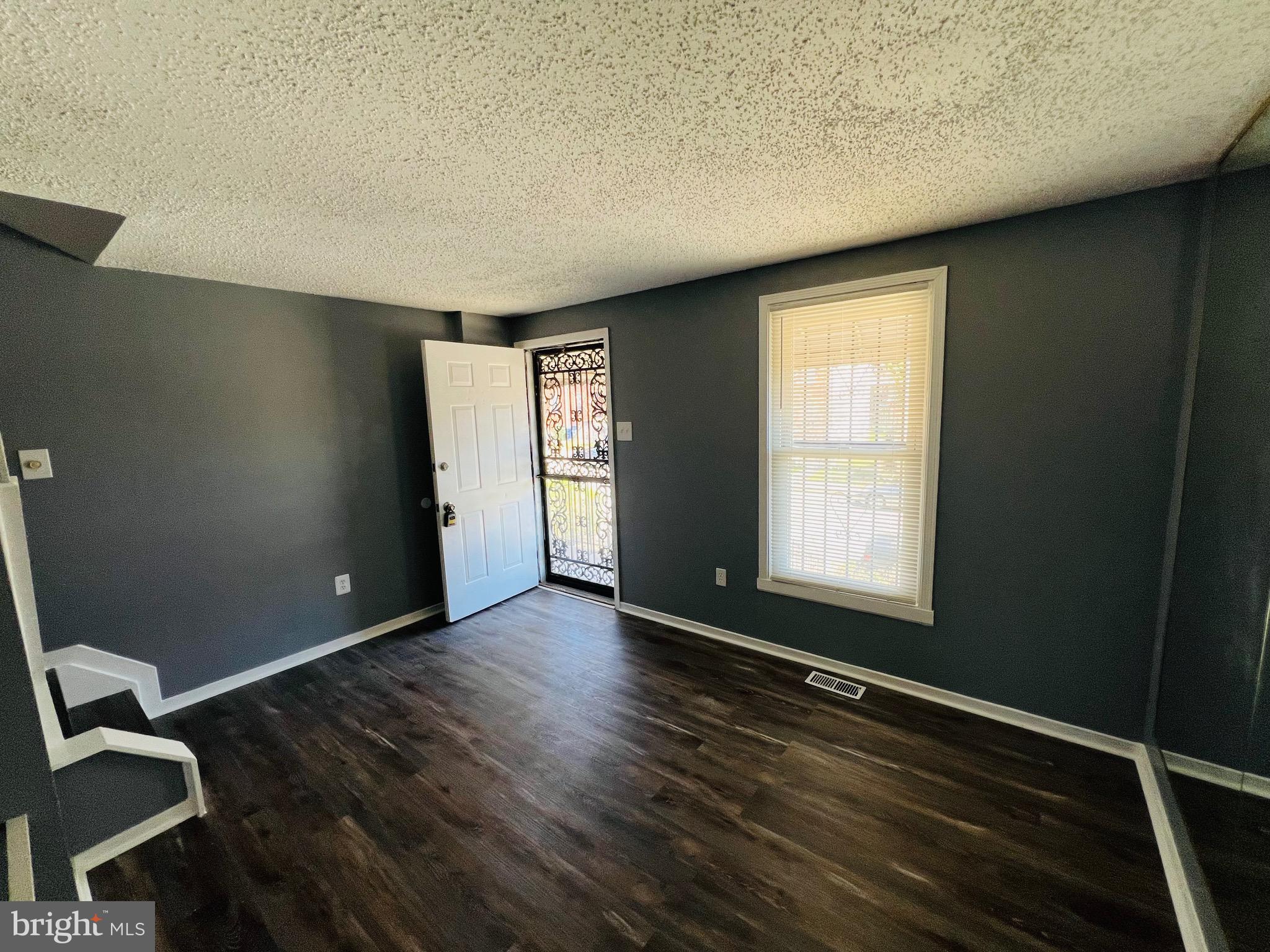 1808 North Spring Street Baltimore, MD 21213 - Photo 8 of 24 an empty room with wooden floor and windows