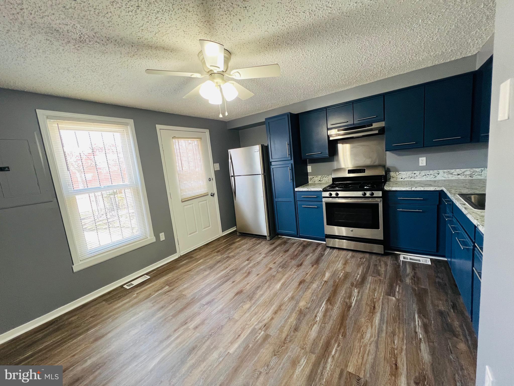 1808 North Spring Street Baltimore, MD 21213 - Photo 9 of 24 a kitchen with stainless steel appliances granite countertop a sink stove and refrigerator