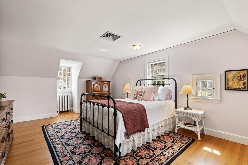 6 Lantern Lane Winchester, MA 01890 - Photo 20 of 40 a bedroom with a bed and wooden floor