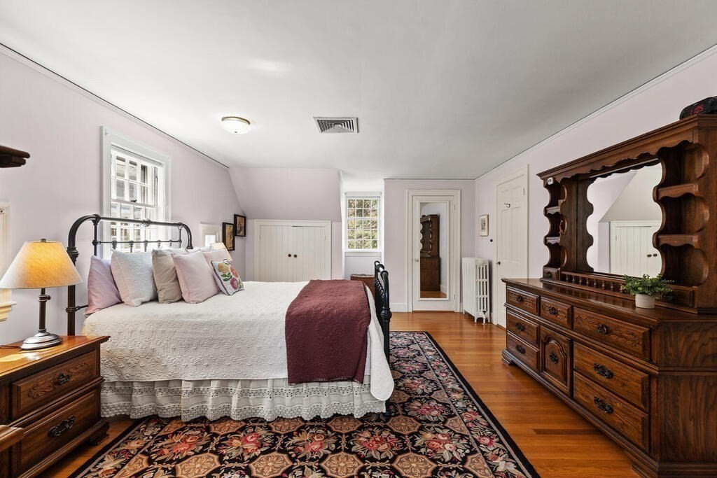 6 Lantern Lane Winchester, MA 01890 - Photo 22 of 40 a bedroom with a bed and dresser with mirror