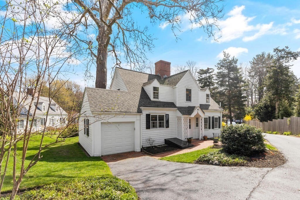 6 Lantern Lane Winchester, MA 01890 - Photo 3 of 40 a front view of a house with a yard and garage